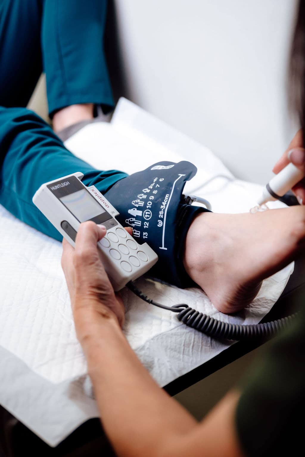 ABPI and hand-held Doppler assessment being performed